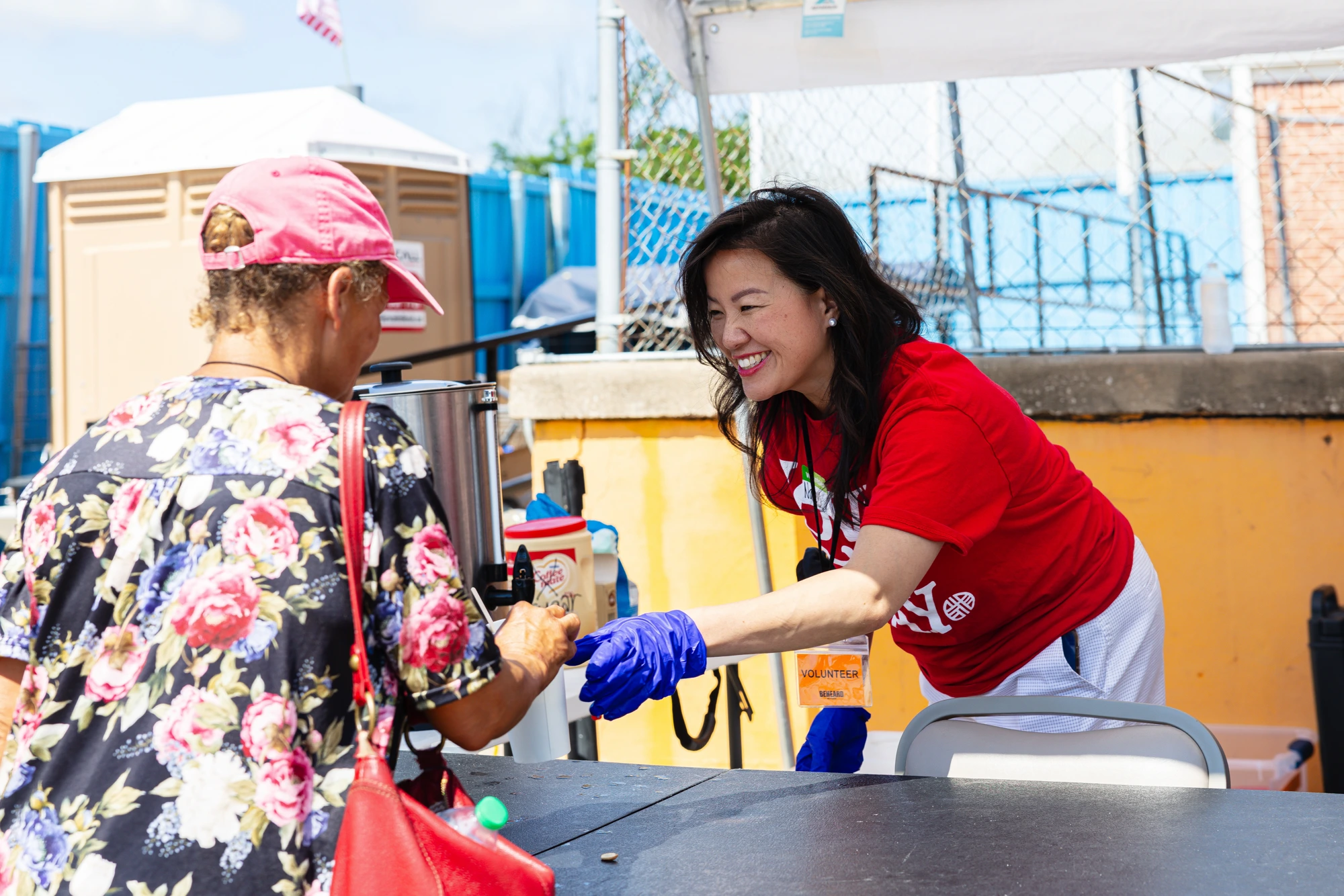 A BeHeard volunteer serving a guest at Love Day